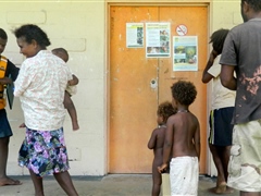 Villagers viewing promotional posters